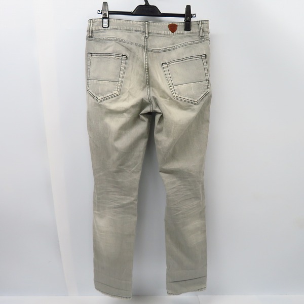 実際に弊社で買取させて頂いたAKM×HTC/エーケーエム×エイチティーシー スタッズ デニムパンツ/Lの画像 1枚目