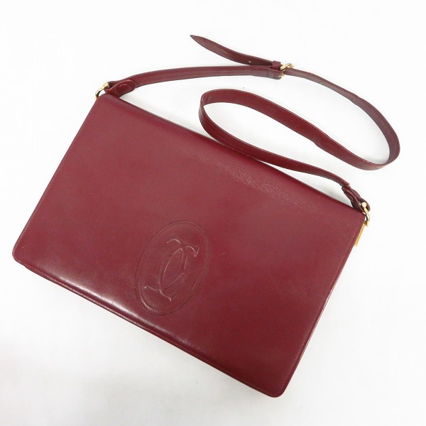 実際に弊社で買取させて頂いたCartier/カルティエ ロゴ マストライン レザー ショルダーバッグ ボルドー/レザー がま口三つ折り財布 ボルドー 2点セットの画像 1枚目