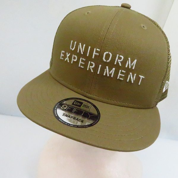 実際に弊社で買取させて頂いた【未使用】ユニフォームエクスペリメント×ニューエラ 9FIFTY SNAP BACK STENCIL LOGO キャップ UE-200086/FREE