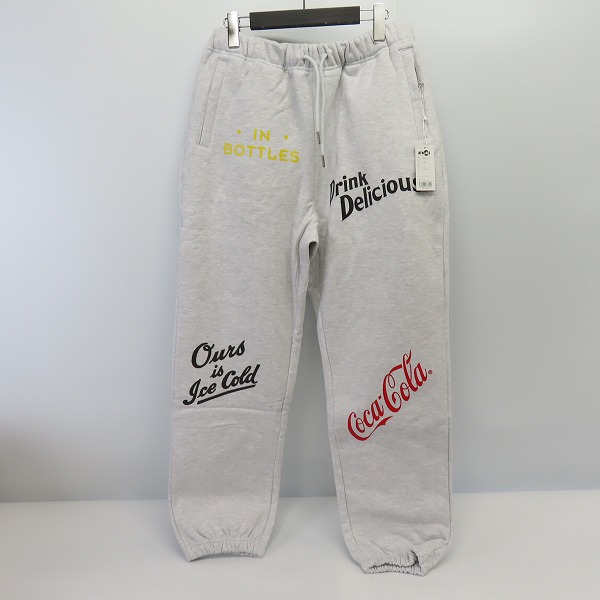 実際に弊社で買取させて頂いた【未使用】ATMOS × COCA-COLA/アトモス×コカ コーラ DRINK DELICIOUS スウェットパンツ AT20-052/L