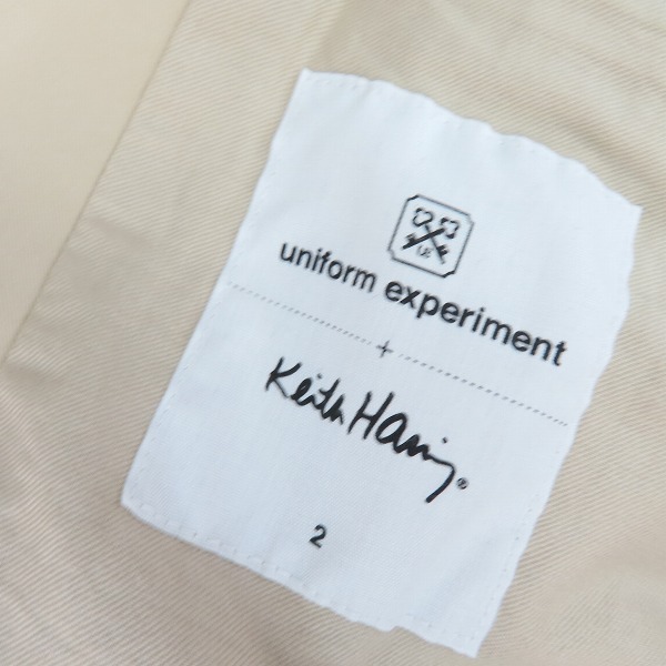 実際に弊社で買取させて頂いたUNIFORM EXPERIMENT×KITH HARING/ユニフォームエクスペリメント×キースヘリング ショートトレンチコート UE-112007/2の画像 2枚目