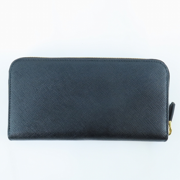 実際に弊社で買取させて頂いたPRADA/プラダ TRIANGOLO PORTAFOGLIO SAFFIANO/サフィアーノレザー トライアングルロゴ ラウンドジップ 長財布 1ML506 QHHの画像 1枚目